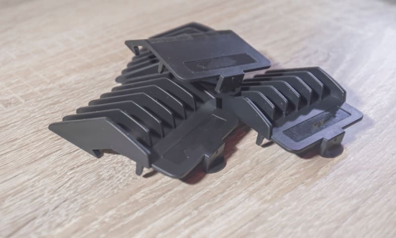 Black plastic injection molded parts with angled design