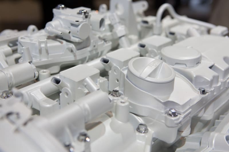 White plastic engine components assembly