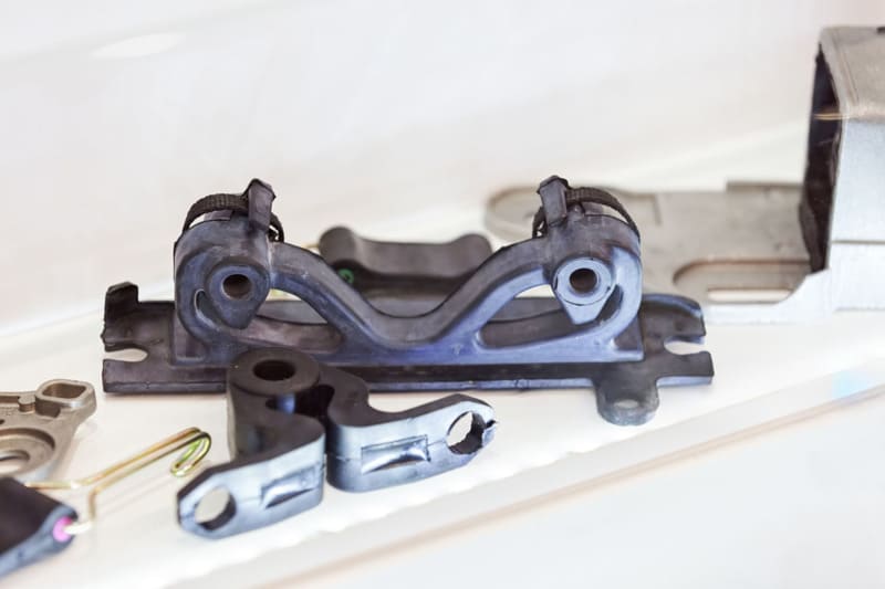 Black plastic automotive brackets and parts