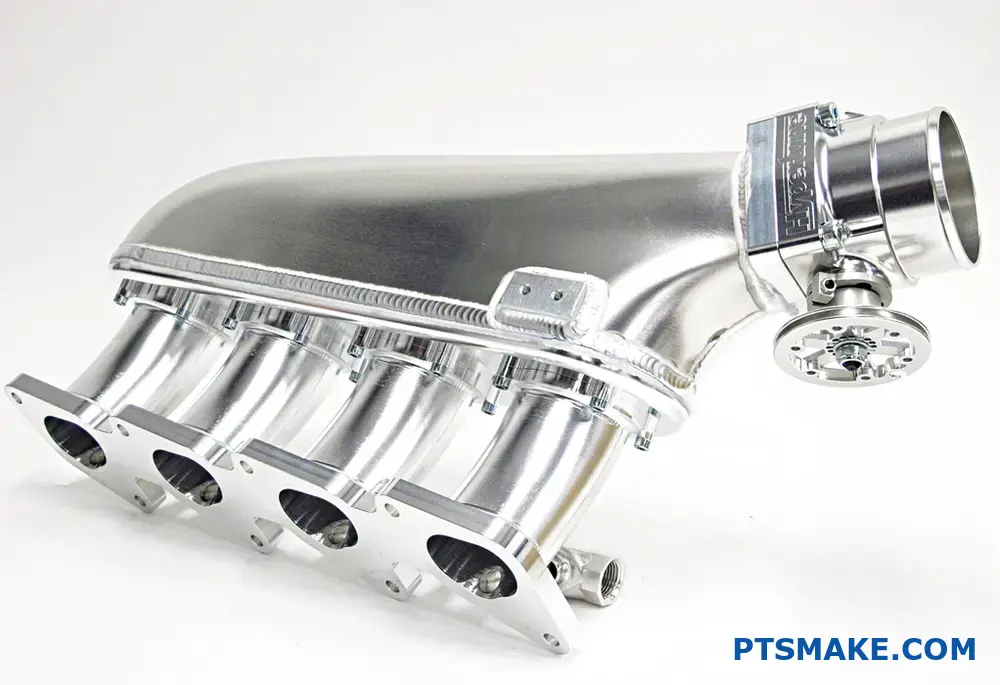 Aluminum CNC machined engine intake manifold on display table