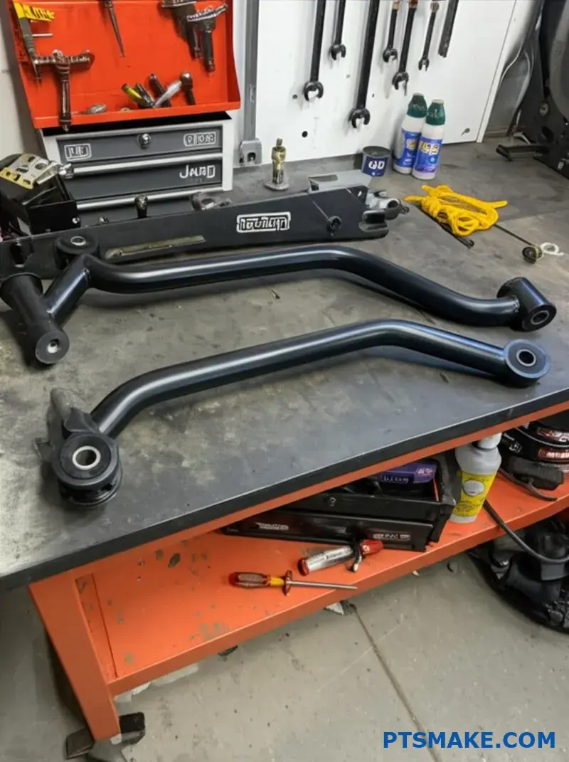 Heavy-duty Jeep control arms on workbench for off-road upgrades